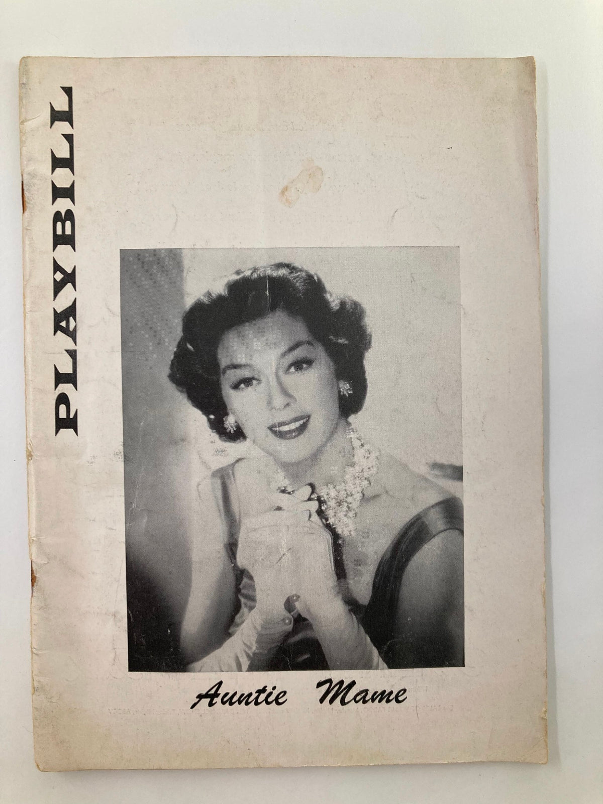 1957 Playbill for Auntie Mame featuring Rosalind Russell on the cover, showcasing vintage Broadway theatrical art.