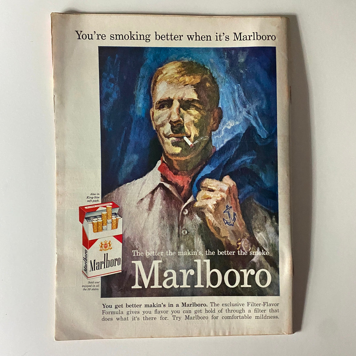 Marlboro advertisement page from a vintage magazine showcasing a rugged man smoking a cigarette. The ad promotes the brand's slogan emphasizing the quality of their tobacco.