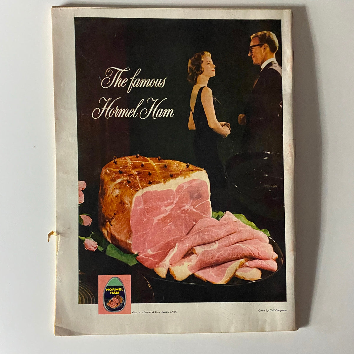 Vintage advertisement for Hormel Ham, featuring a stylish couple and a beautifully presented ham, highlighting classic 1950s culinary culture.