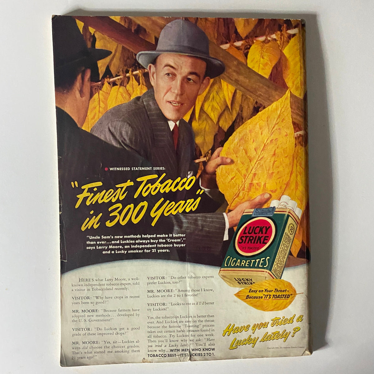 Mademoiselle Magazine November 1939 advertisement for Lucky Strike cigarettes, featuring a man in a hat discussing tobacco, surrounded by autumn leaves, highlighting vintage advertising styles.