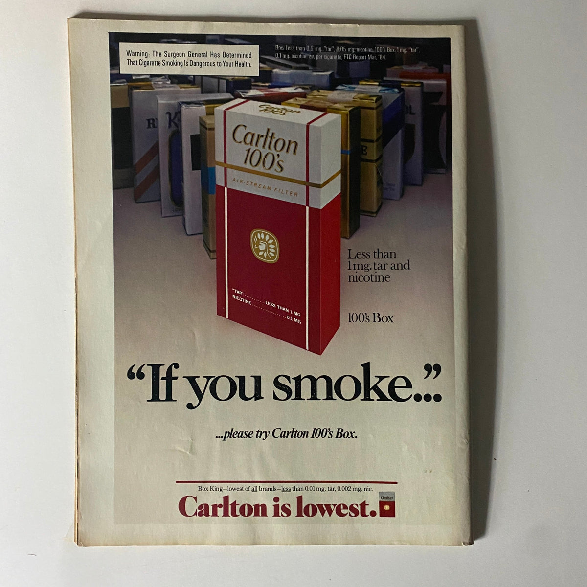 Advertisement for Carlton 100's Box cigarettes from the August 27, 1984 edition of Newsweek Magazine, showcasing the product with the slogan "If you smoke... please try Carlton 100's Box." Featured title: Newsweek Magazine August 27 1984 Ronald Reagan Cover.