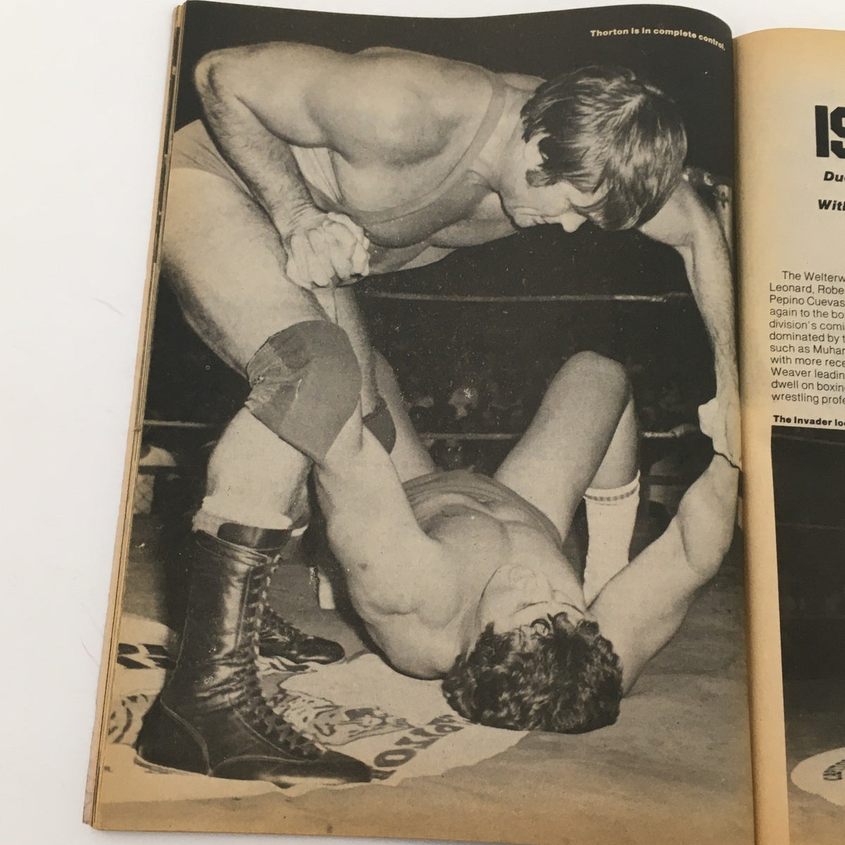 Black and white image from Wrestling Today Magazine, January 1981 showing wrestlers in a grappling match, highlighting the intense action of professional wrestling.