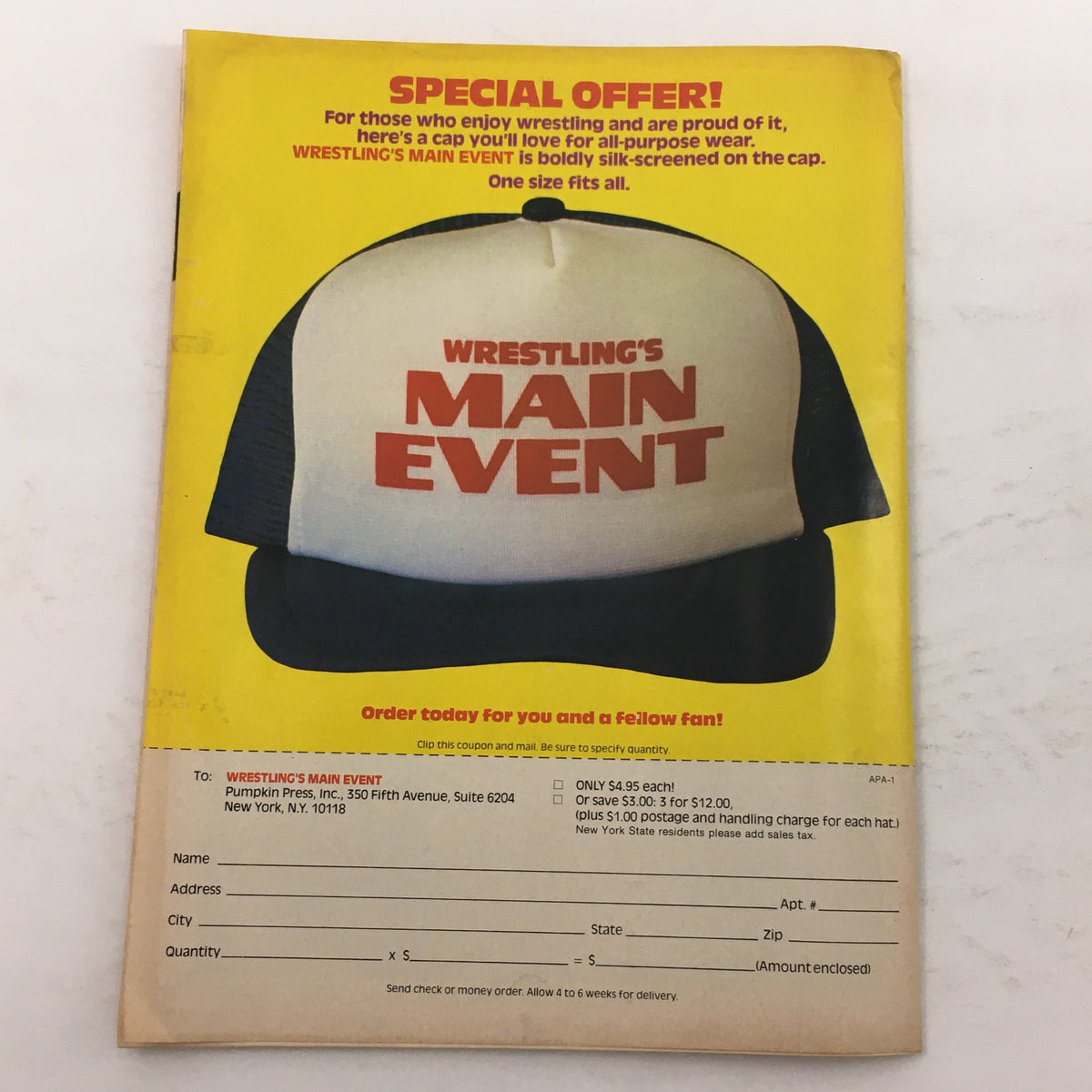 Back cover of the Wrestling Action Photo Album 1982 Vol 1 showcasing a special offer for a cap prominently displaying 'Wrestling's MAIN EVENT'. The layout features ordering details for wrestling fans.
