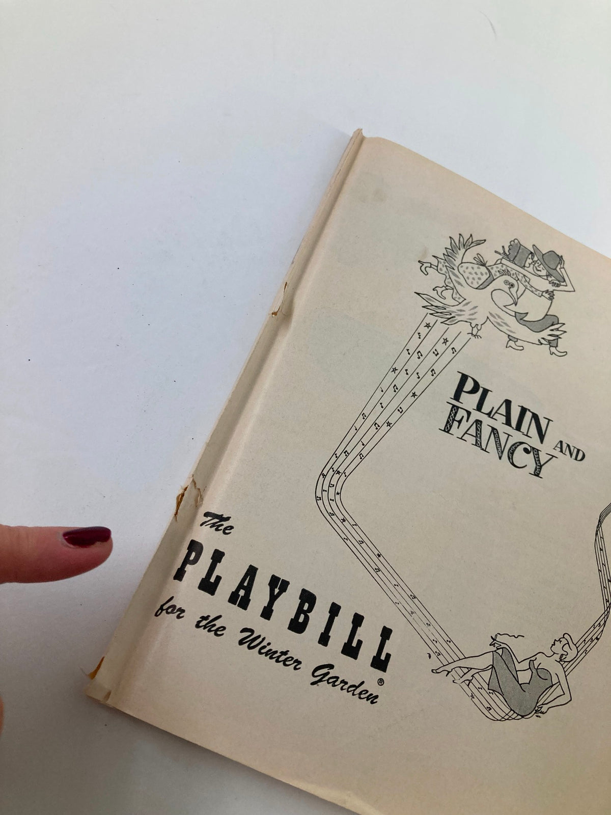 Close-up of the 1955 Playbill for 'Plain and Fancy' highlighting the vintage design and wear from the Winter Garden Theatre performances.