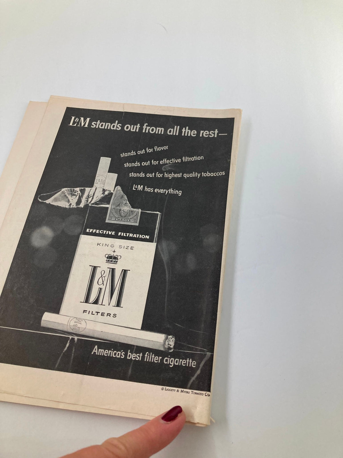 Back cover of the 1955 Playbill for 'Plain and Fancy', featuring an advertisement for L&M cigarettes, reflecting historical marketing practices.