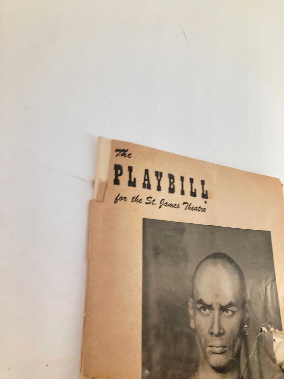 Close-up of the top of the 1953 Playbill from St. James Theatre featuring Yul Brynner in The King and I, showcasing the title and a black and white image of Yul Brynner.