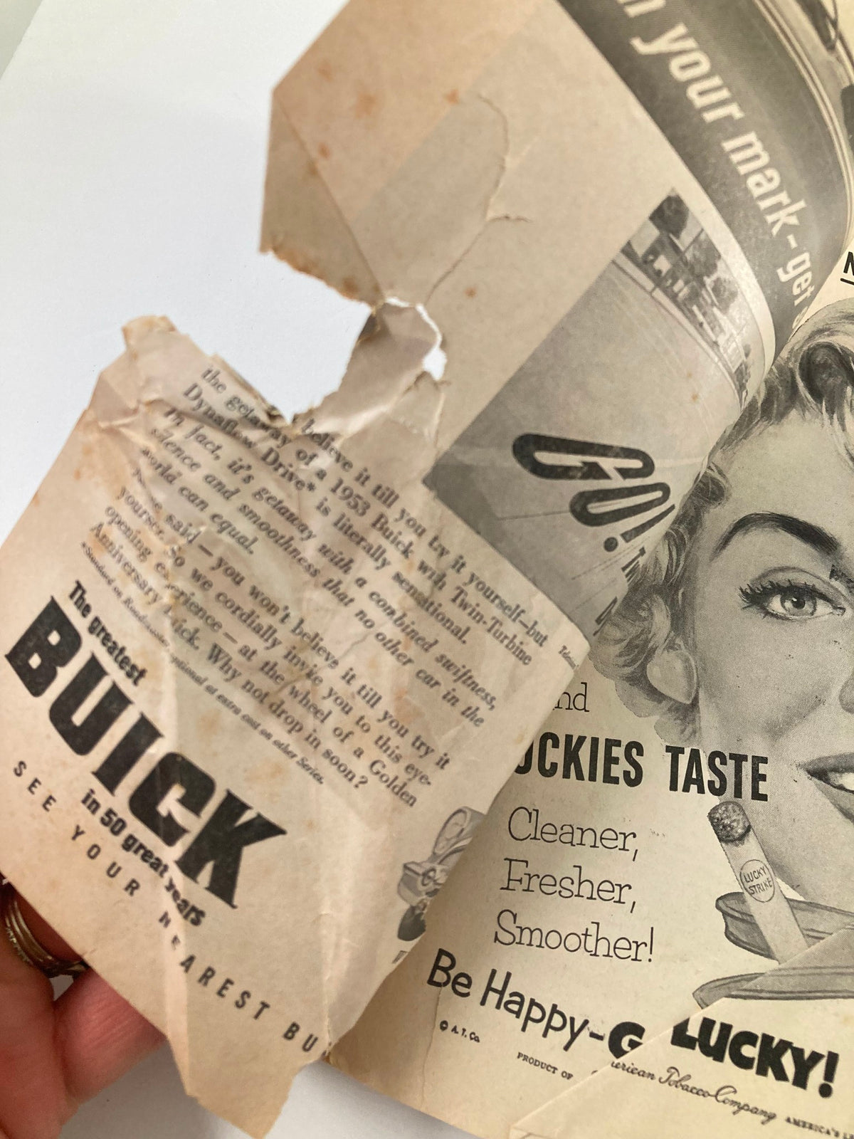 Interior page of the 1953 Playbill from St. James Theatre, displaying ads for Buick and Lucky Strike, highlighting vintage advertisements from the era.