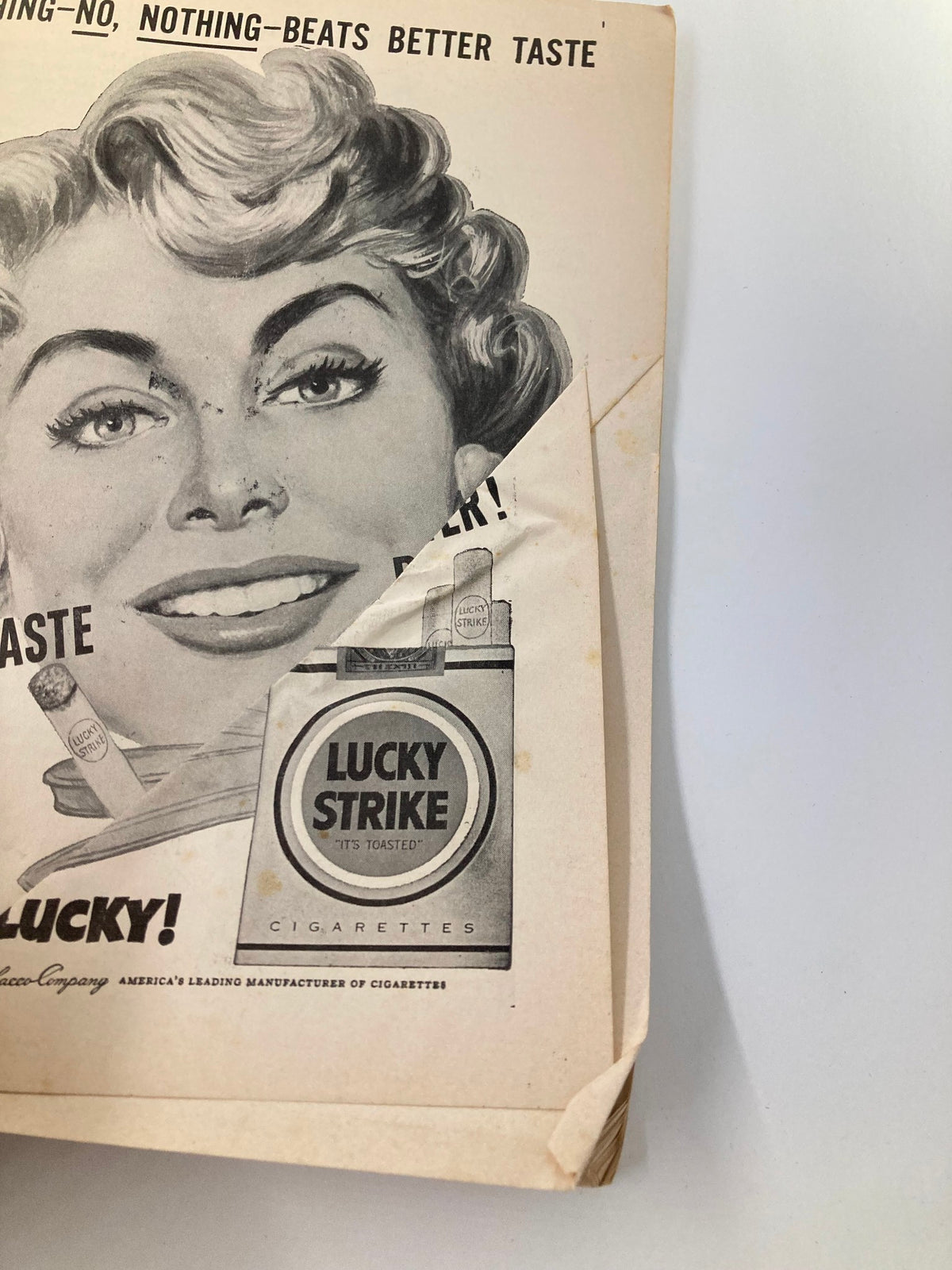 Detailed advertisement from the 1953 Playbill from St. James Theatre, focusing on Lucky Strike cigarettes with an engaging illustration of a woman, reflective of mid-20th century advertising.