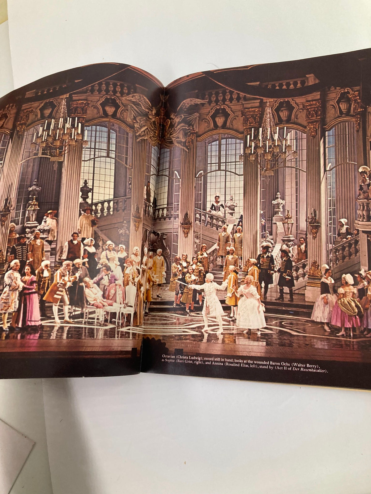 Vibrant scene from a production in the 1968 Program Souvenir Metropolitan Opera Association Annual Report, depicting a lavish opera performance with a cast and intricate stage setting.