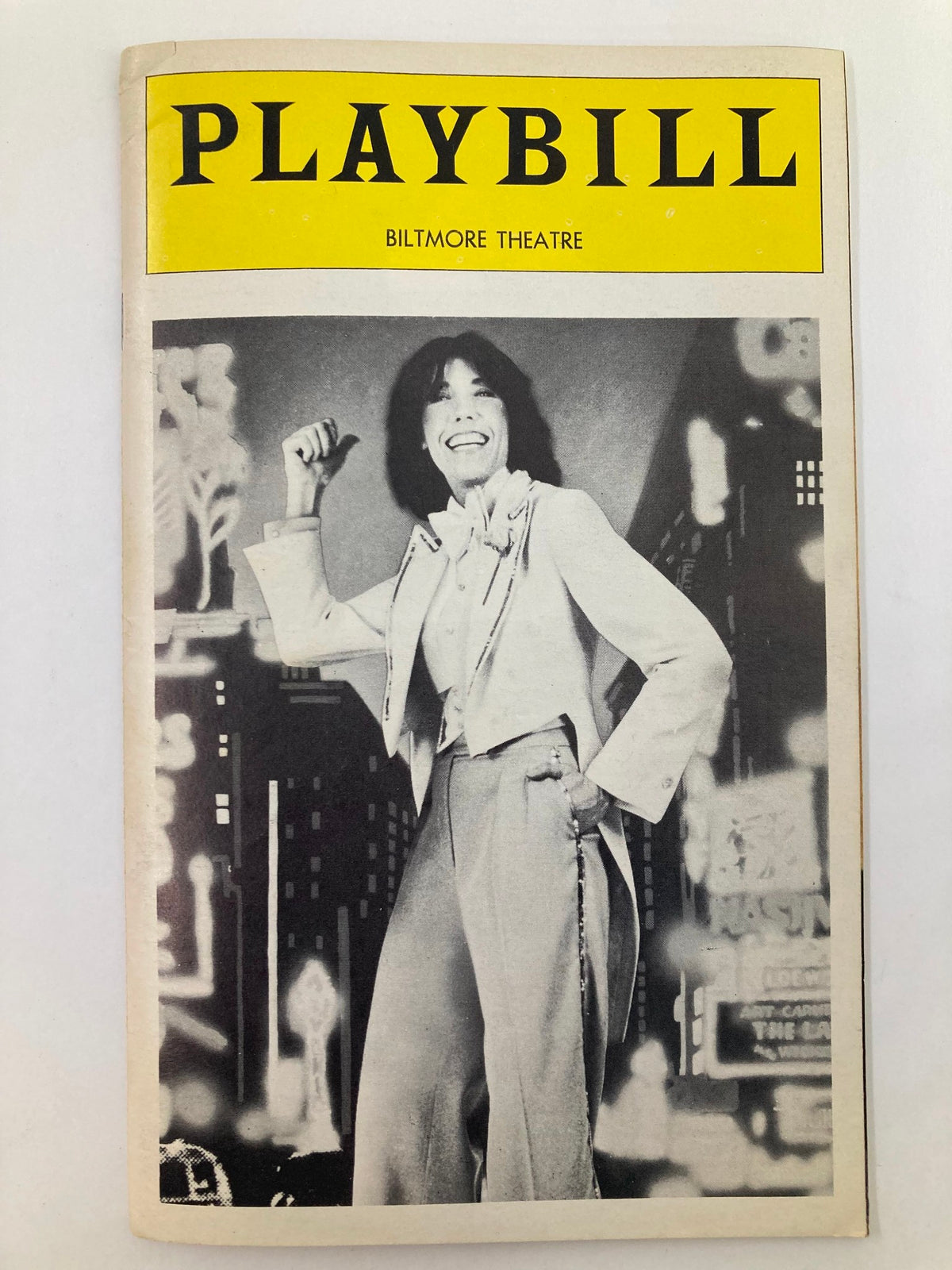 1977 Playbill from Biltmore Theatre featuring Lily Tomlin in Appearing Nitely, showcasing a black and white photo of Tomlin in a stylish outfit with a vibrant city backdrop.