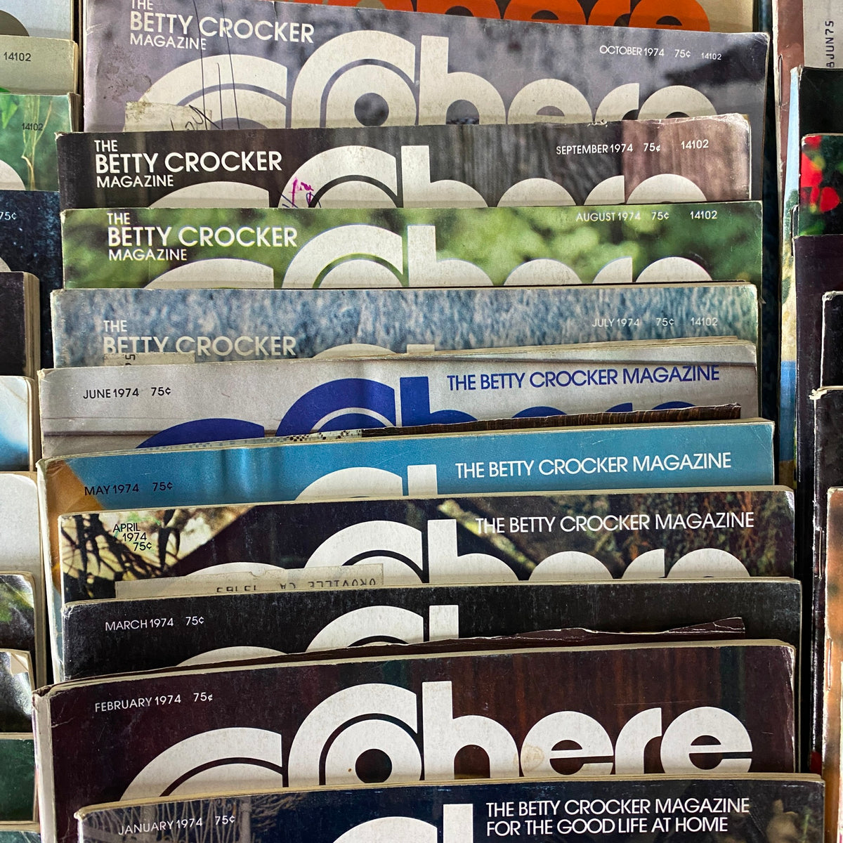Comprehensive assortment of Betty Crocker Sphere magazines from 1974, featuring vibrant cover designs and unique recipes from the 1970s. Targeted towards collectors of retro cooking publications.