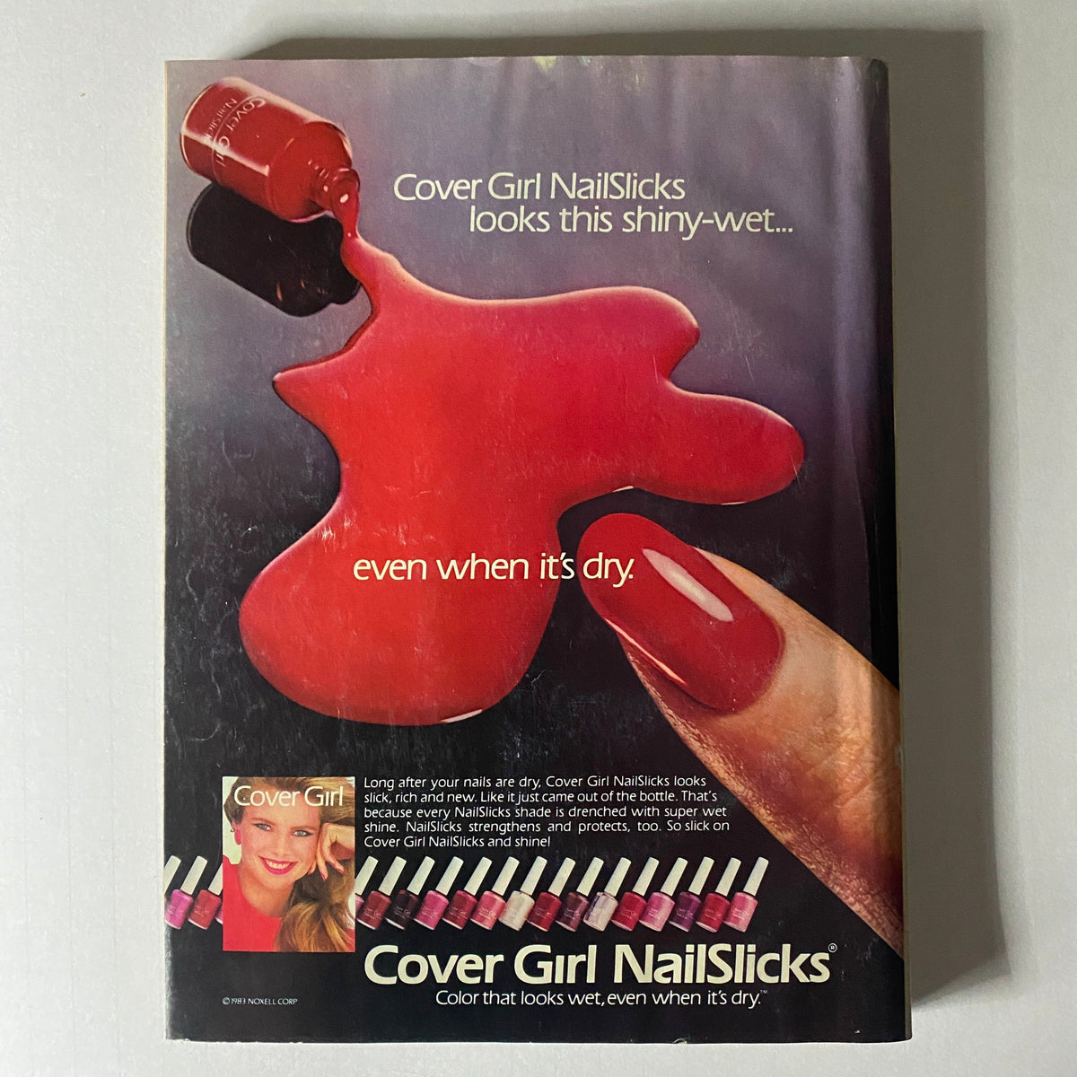 Advertisement for Cover Girl NailSlicks featured in Glamour Magazine September 1983, promoting shiny nail polish with a bold red theme.