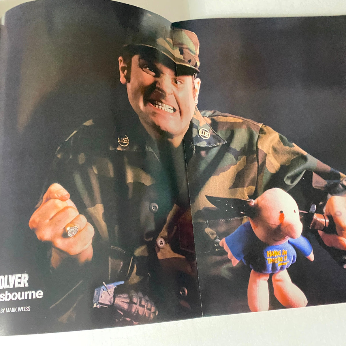 Feature from Revolver Magazine March 2005 Dimebag Darrell Cover showing Ozzy Osbourne in military attire with a comical teddy bear. This vintage edition offers insights into the rock music scene.