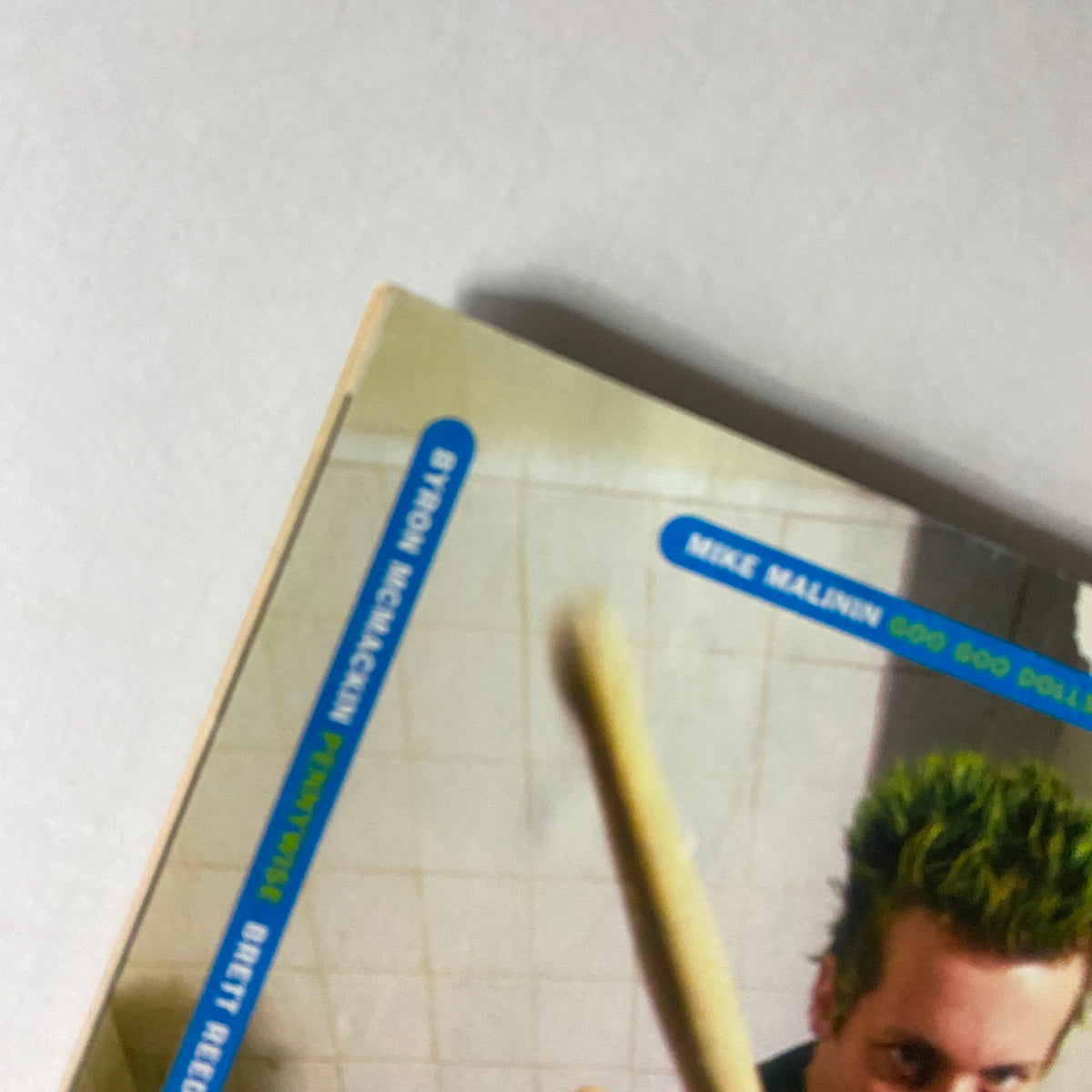 Close-up of an advertisement featuring Tre Cool from Green Day promoting Zildjian drumsticks, included in Hit Parader Magazine, November 1998.