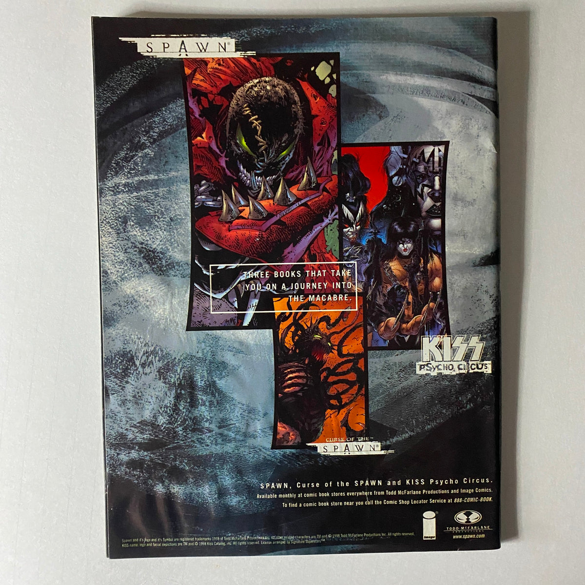 Promotional artwork for KISS Psycho Circus alongside Spawn, featured in the 1998 Premiere Issue of Todd McFarlane Presents Kiss Psycho Circus, indicating a crossover.