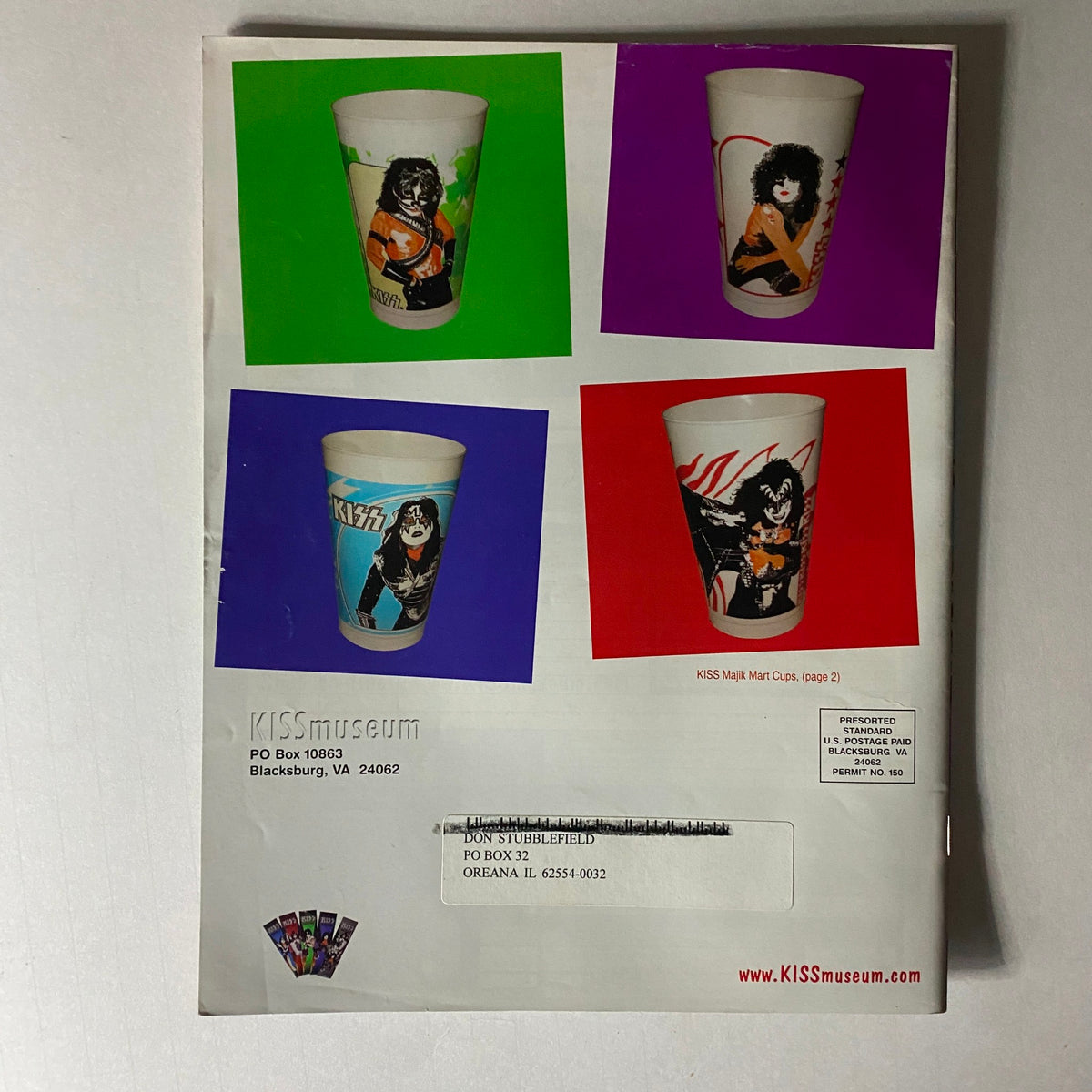Back cover of the KISS Museum.com Catalog Fall 2003 displaying KISS-themed drink cups with vibrant designs.