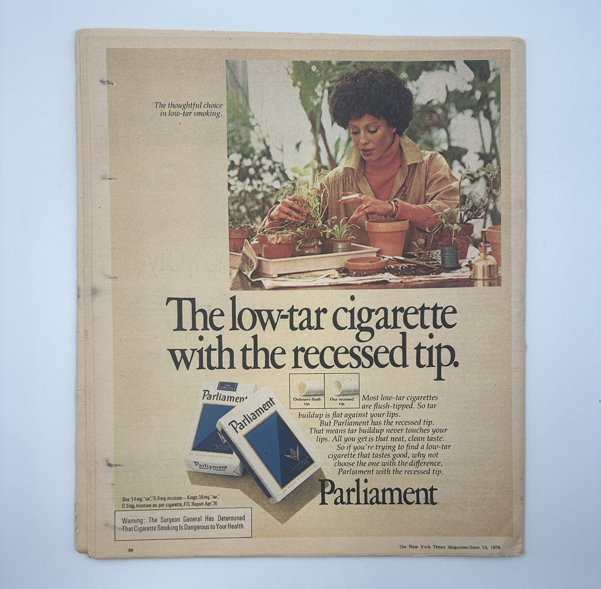 Advertisement from The New York Times Magazine June 13, 1976 promoting Parliament low-tar cigarettes, featuring a woman engaged in thoughtful activity, emphasizing the product's design and smoking features.