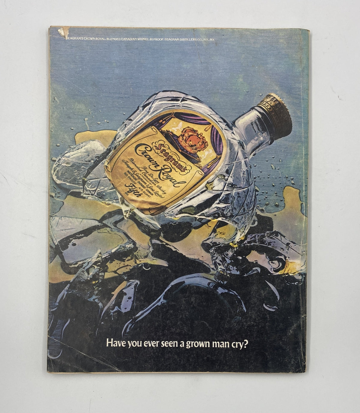 Back cover of Esquire Magazine, May 1976 featuring a creative advertisement for Crown Royal whiskey with an artistic design. A peek into the promotional style of the 1970s lifestyle.
