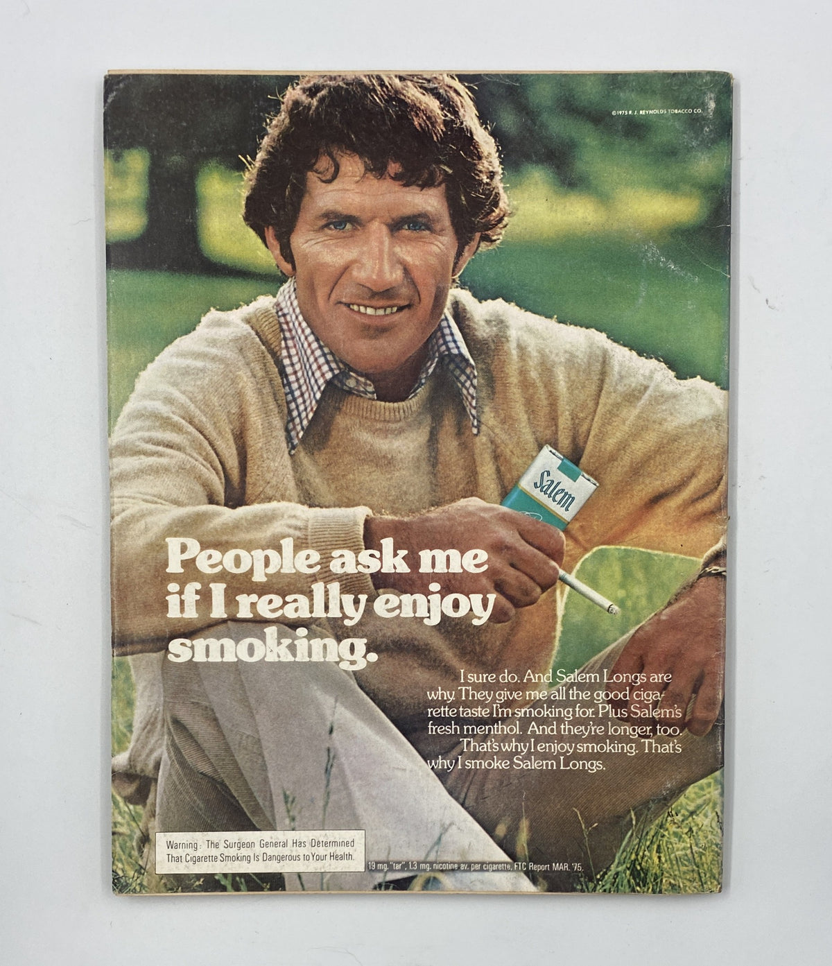Back cover of Esquire Magazine, January 1976, showcasing a man in a sweater promoting Salem Long cigarettes with the tagline 'People ask me if I really enjoy smoking.'