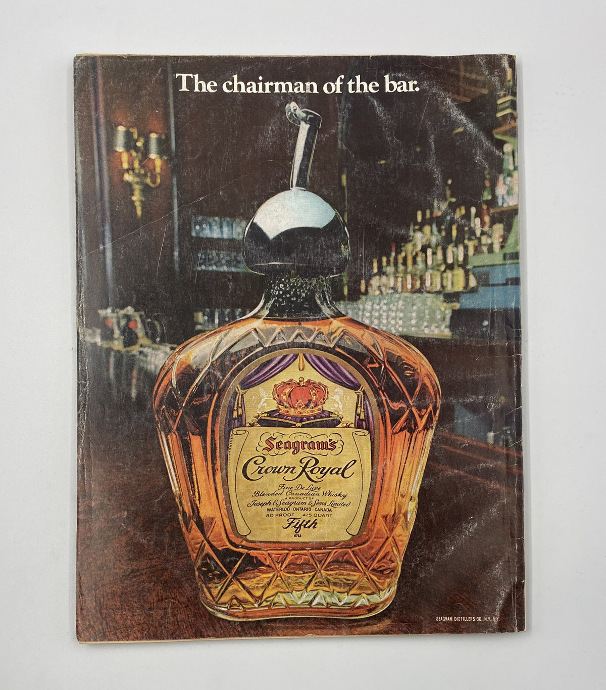 Back cover of Esquire Magazine April 1976 featuring a classic Seagram's Crown Royal advertisement, emphasizing the whiskey brand with the slogan 'The chairman of the bar.' This iconic design reflects vintage advertising aesthetics.