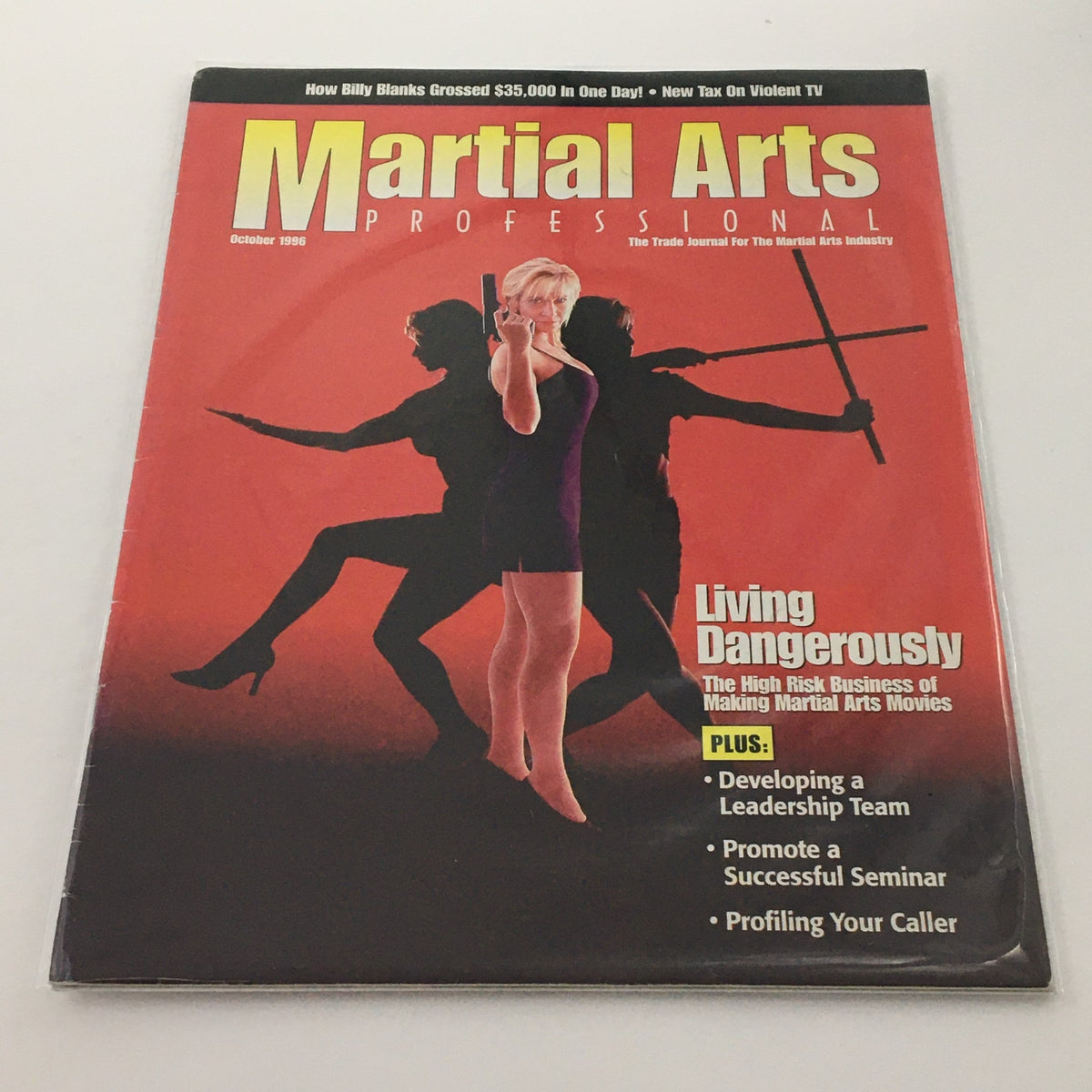 Martial Arts Professional Magazine October 1996 cover featuring an image of a woman holding a telephone, with silhouettes of martial artists in the background. The magazine includes articles on living dangerously in the martial arts industry, developing a leadership team, and profiling your caller.