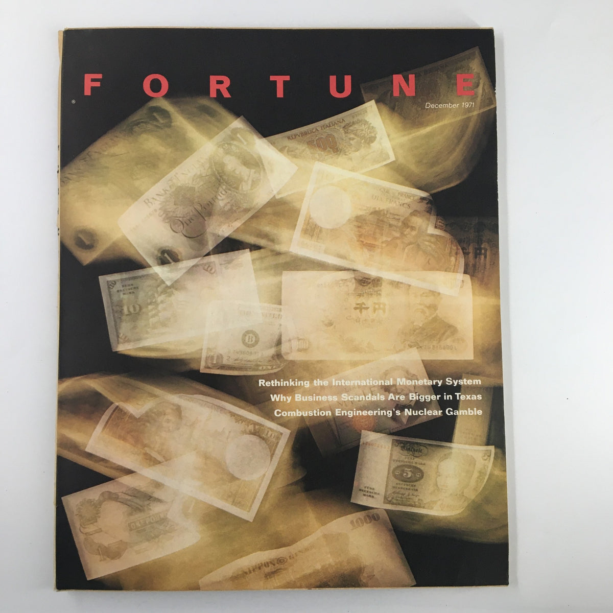 Cover of VTG Fortune Magazine December 1971 featuring a dynamic depiction of various international currencies, with the title prominently displayed and topics on monetary systems and business scandals listed.