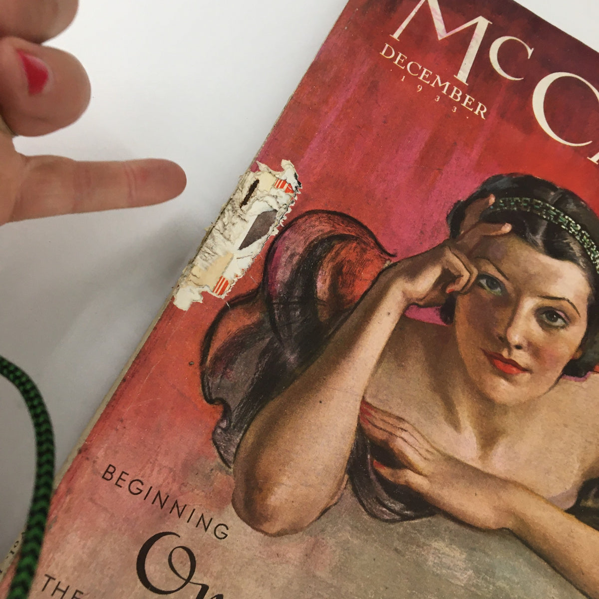 Close-up view of the damaged corner of VTG McCall's Magazine December 1933, revealing details of the cover art and the title 'Once Upon A Time' by Frances N. Hart.