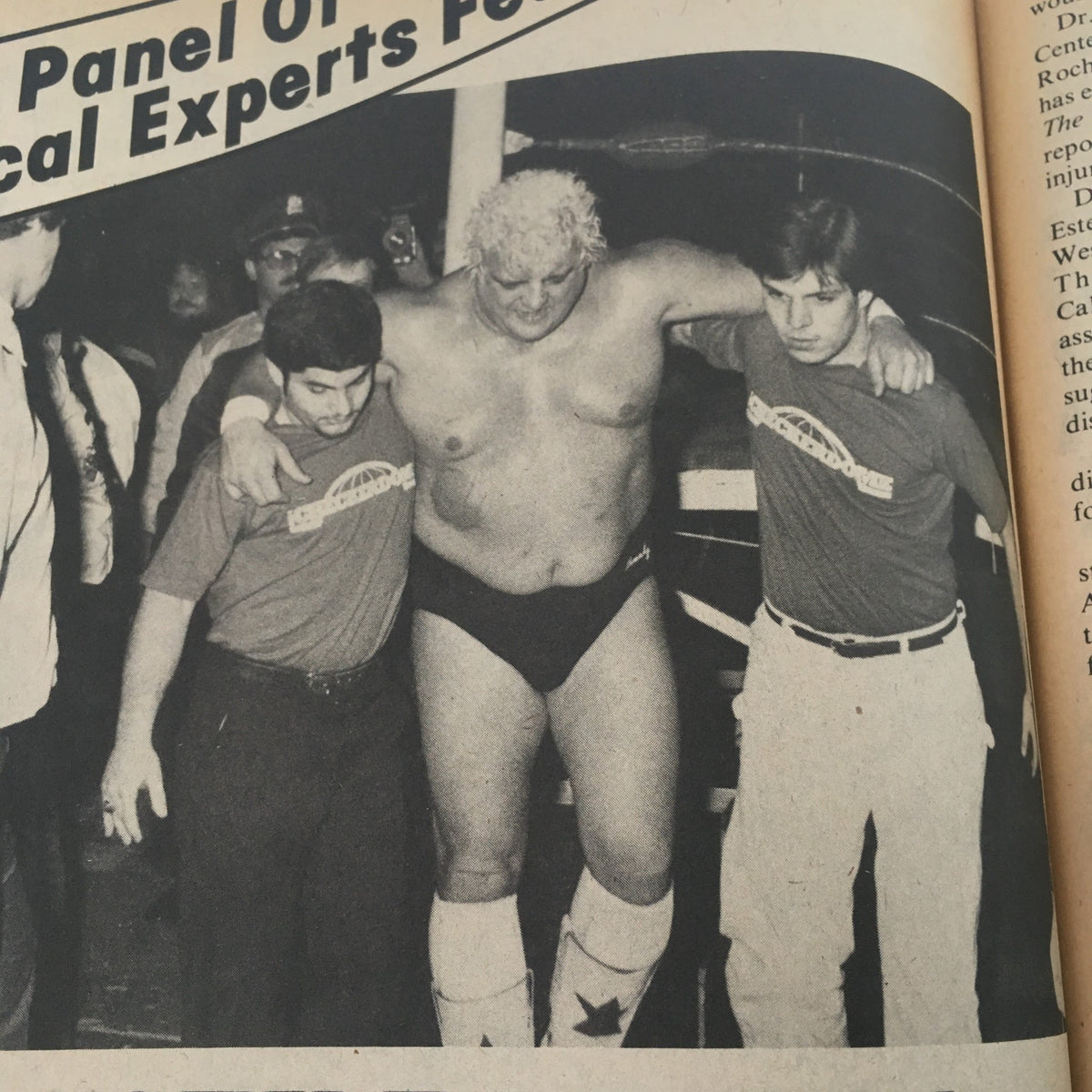 Historical photo from The Wrestler Magazine May 1982 showing a wrestler assisted by two physicians, highlighting the health risks in professional wrestling.