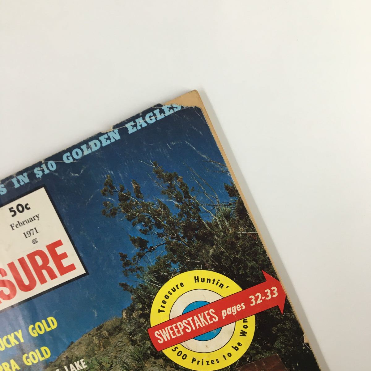 Detail view of the top corner of VTG True Treasure Magazine February 1971 cover, showcasing the title and with additional article highlights including 'Lost Kentucky Gold' and 'Lost Sierra Gold'.