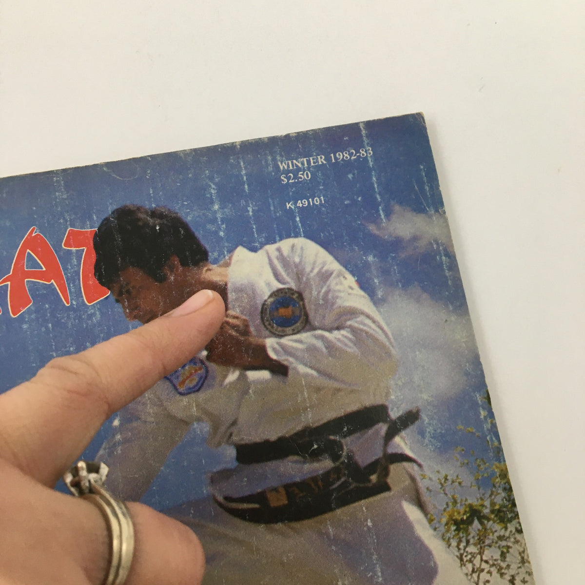 Close-up of the Karate World Magazine Winter 1982-1983 cover, showing details of a martial artist preparing for a technique, with focus on its historical context in Puerto Rico.