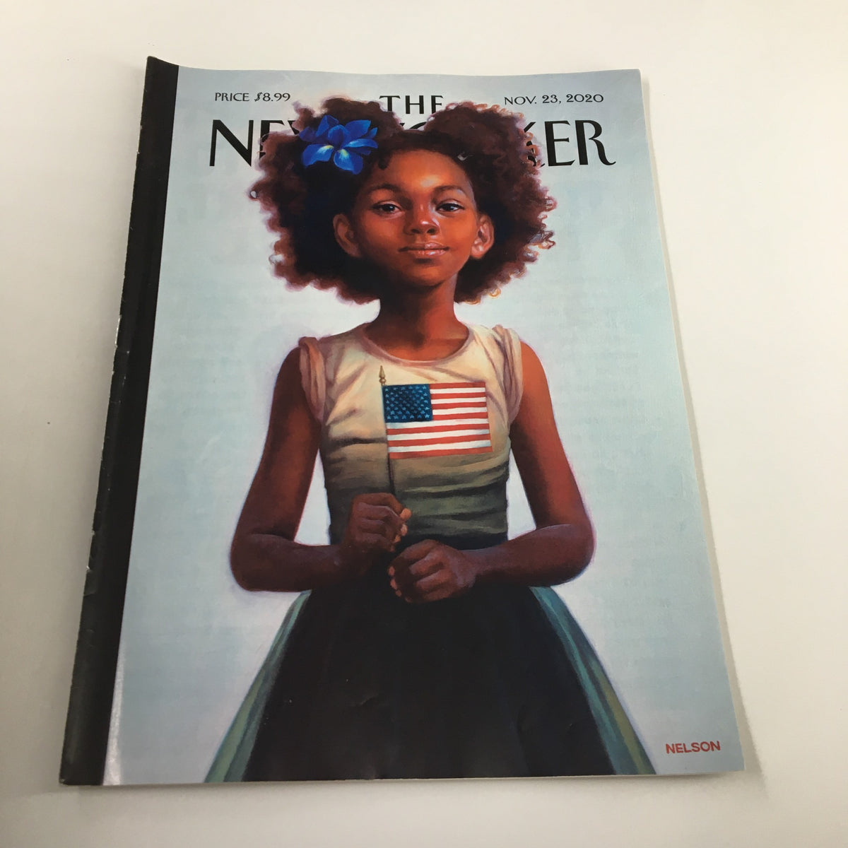 The New Yorker Magazine November 23, 2020 cover featuring a painting by Kadir Nelson, depicting a young girl holding an American flag.