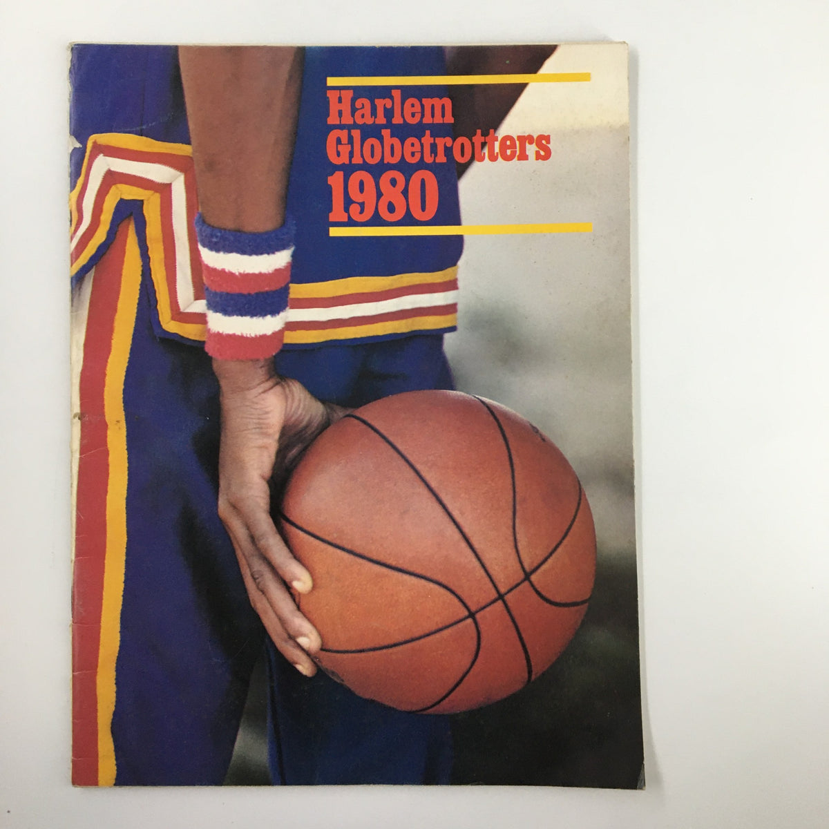 Cover of the 1980 Harlem Globetrotters The Trotters on Tour featuring a player holding a basketball. This vintage magazine highlights the famous basketball team.