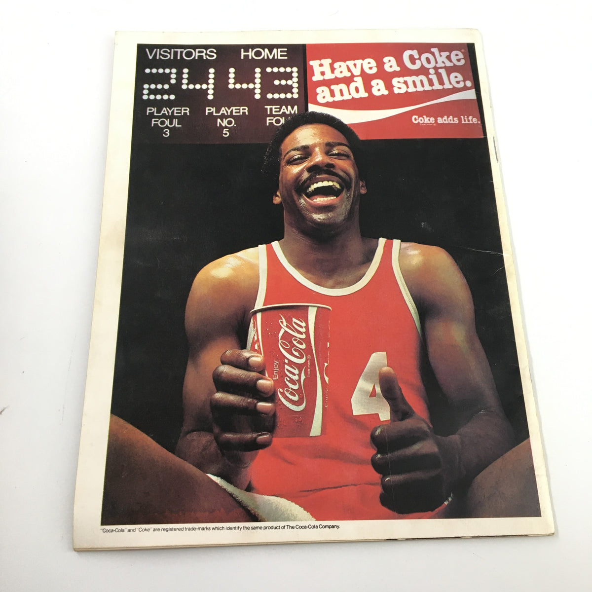 1980 Harlem Globertrotters The Trotters on Tour advertisement featuring a smiling basketball player holding a Coke, reflecting the vibrant culture surrounding the Harlem Globertrotters and their promotional partnerships.
