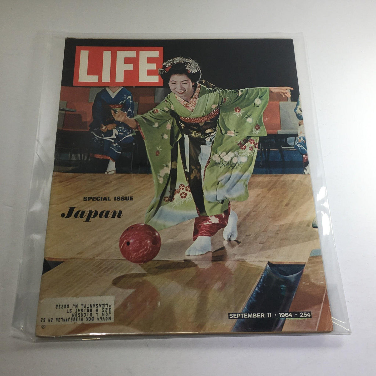 Cover of Life Magazine, September 11, 1964, featuring a geisha in traditional attire bowling, illustrating Japanese culture and leisure activities.