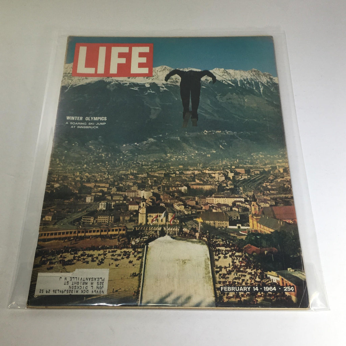 Cover of VTG Life Magazine February 14, 1964 featuring the Winter Olympics Ski Jump at Innsbruck, showcasing a ski jumper soaring above the city with snow-capped mountains in the background.