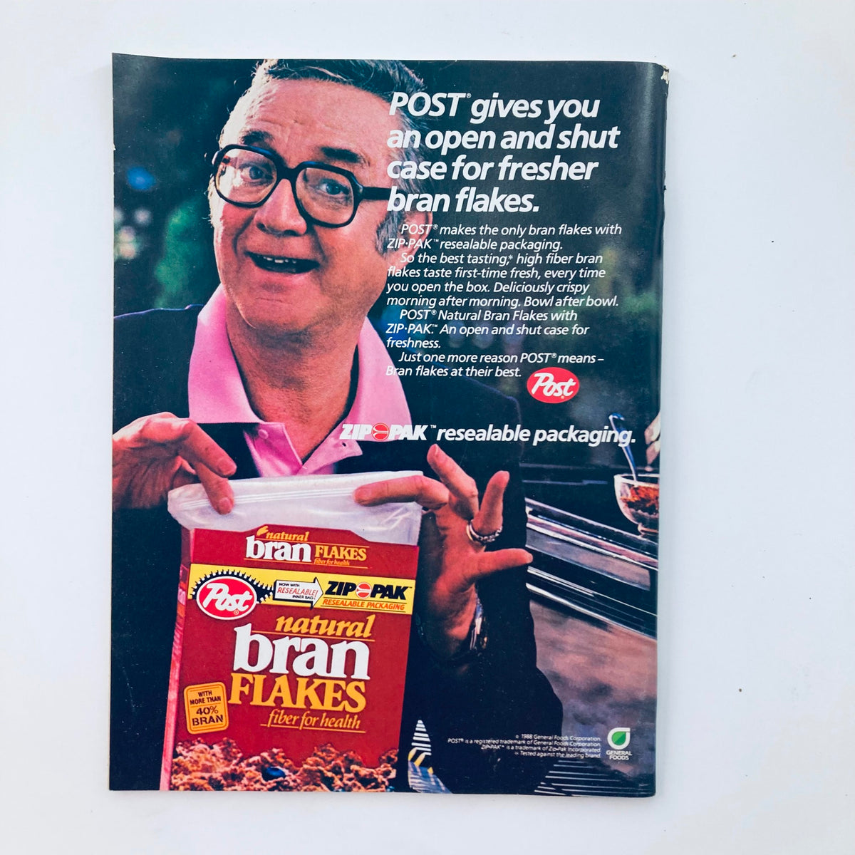 Vintage advertisement for Post Natural Bran Flakes from the Saturday Evening Post Magazine March 1988, showcasing a man holding the cereal box, emphasizing its resealable packaging for freshness.