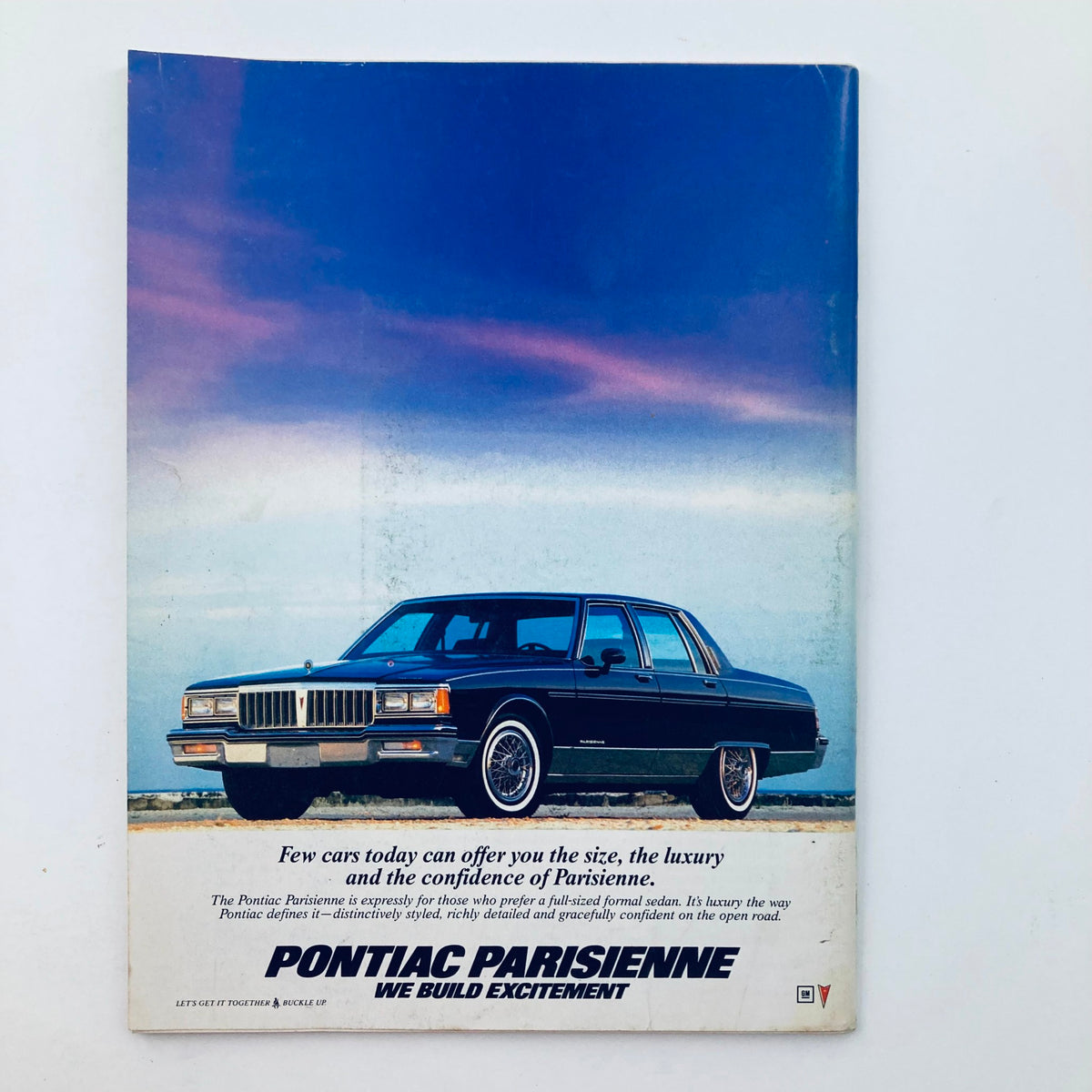 Back cover of the Saturday Evening Post Magazine April 1986 featuring an advertisement for the Pontiac Parisienne luxury car, promoting excitement and style.