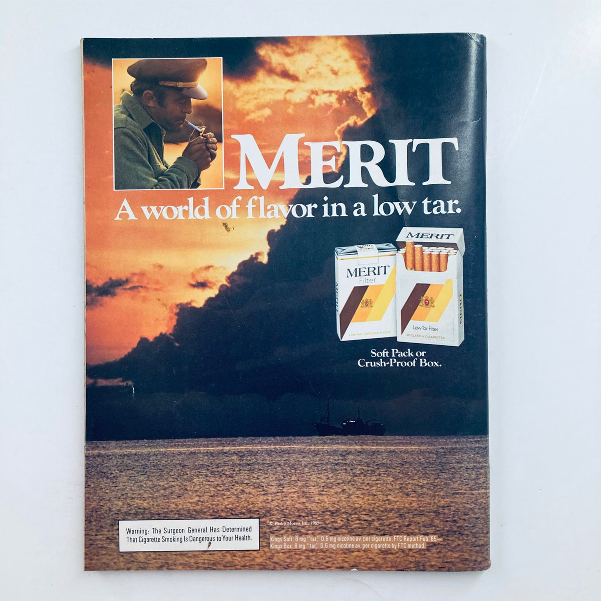 Vintage advertisement for Merit cigarettes displayed in Playboy magazine September 1985, emphasizing a low-tar smoking option against a scenic background.