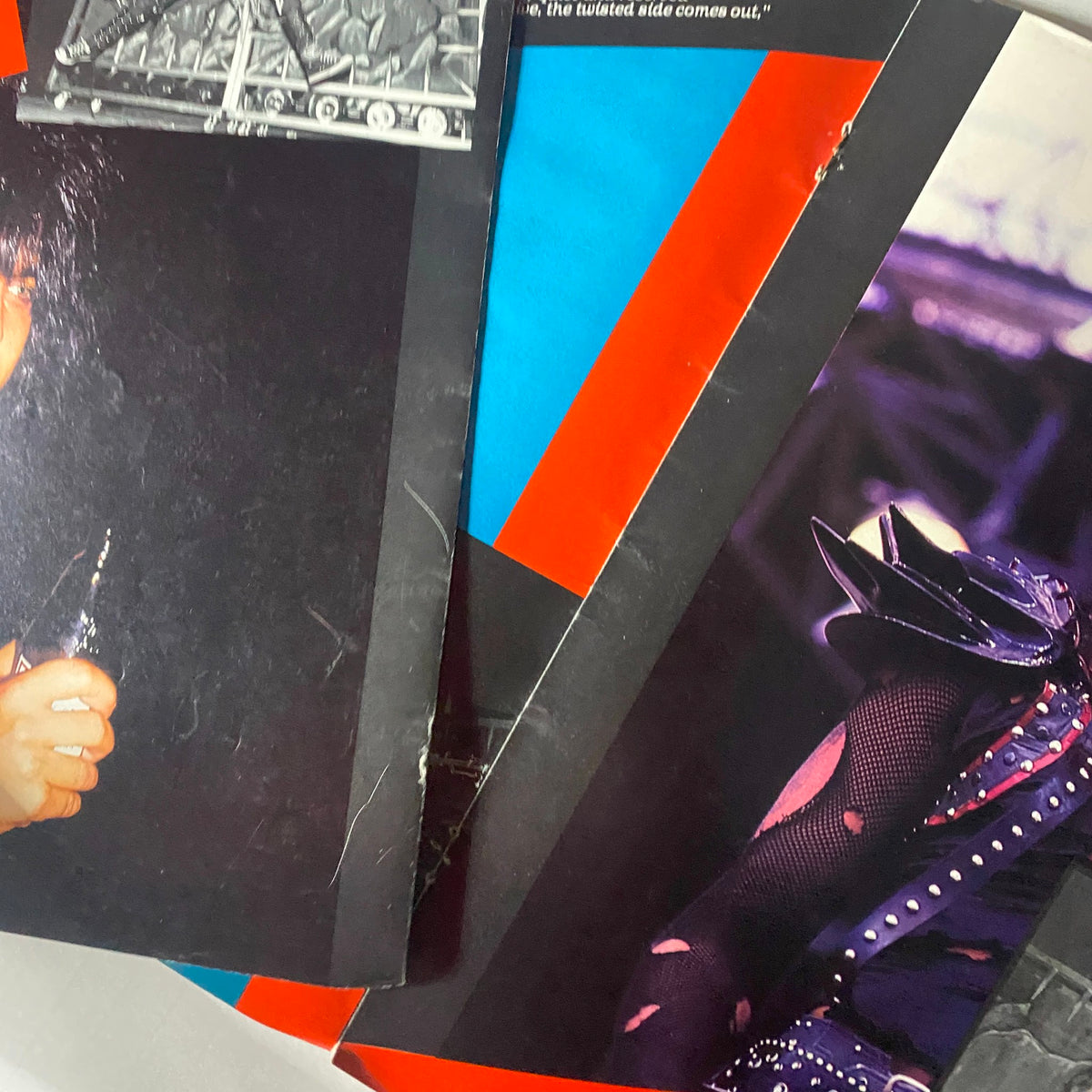 Close-up of Mötley Crüe magazine pages displaying various members in dynamic poses, related to the '1984 Motley Crue Metal Mania Heavy Metal Rare Photo Compilation GD Interior' showcasing unique visuals from their early years.