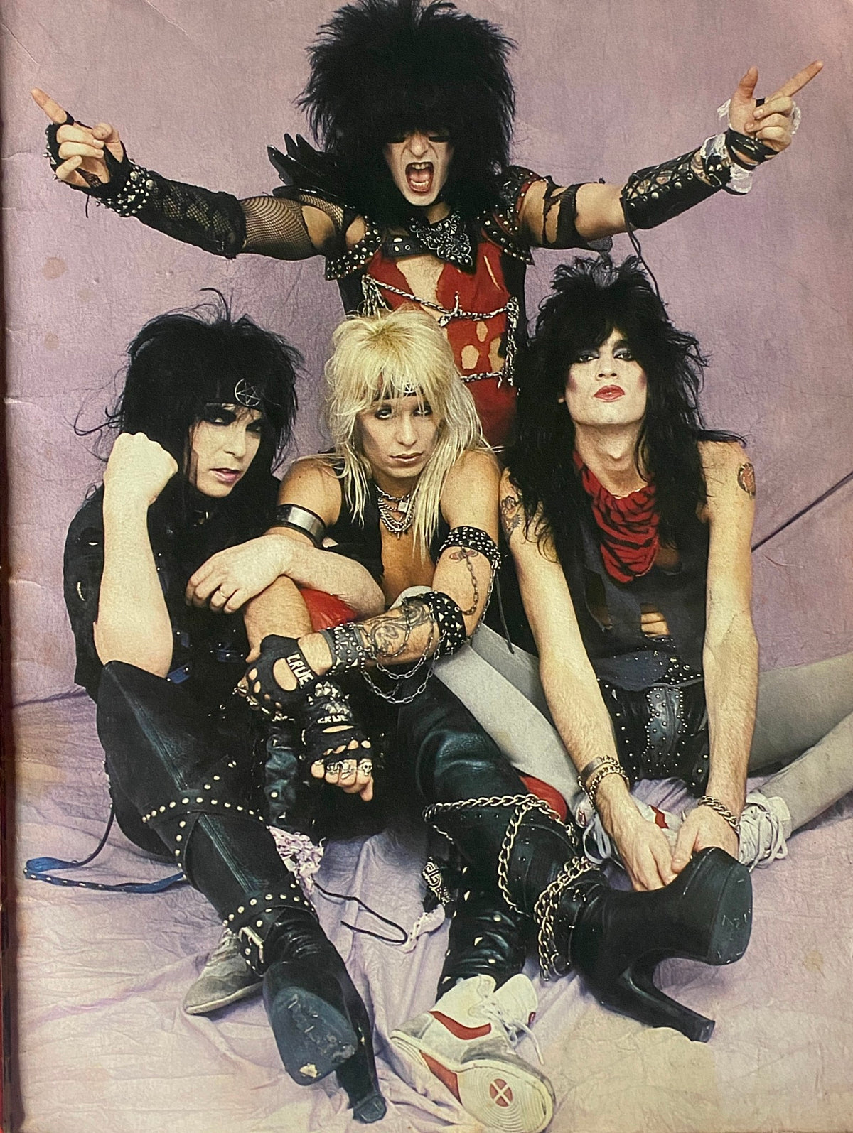 Promotional photo of Mötley Crüe band members posing together, emphasizing their iconic style in the '1984 Motley Crue Metal Mania Heavy Metal Rare Photo Compilation GD Interior', a collectible for rock music fans.