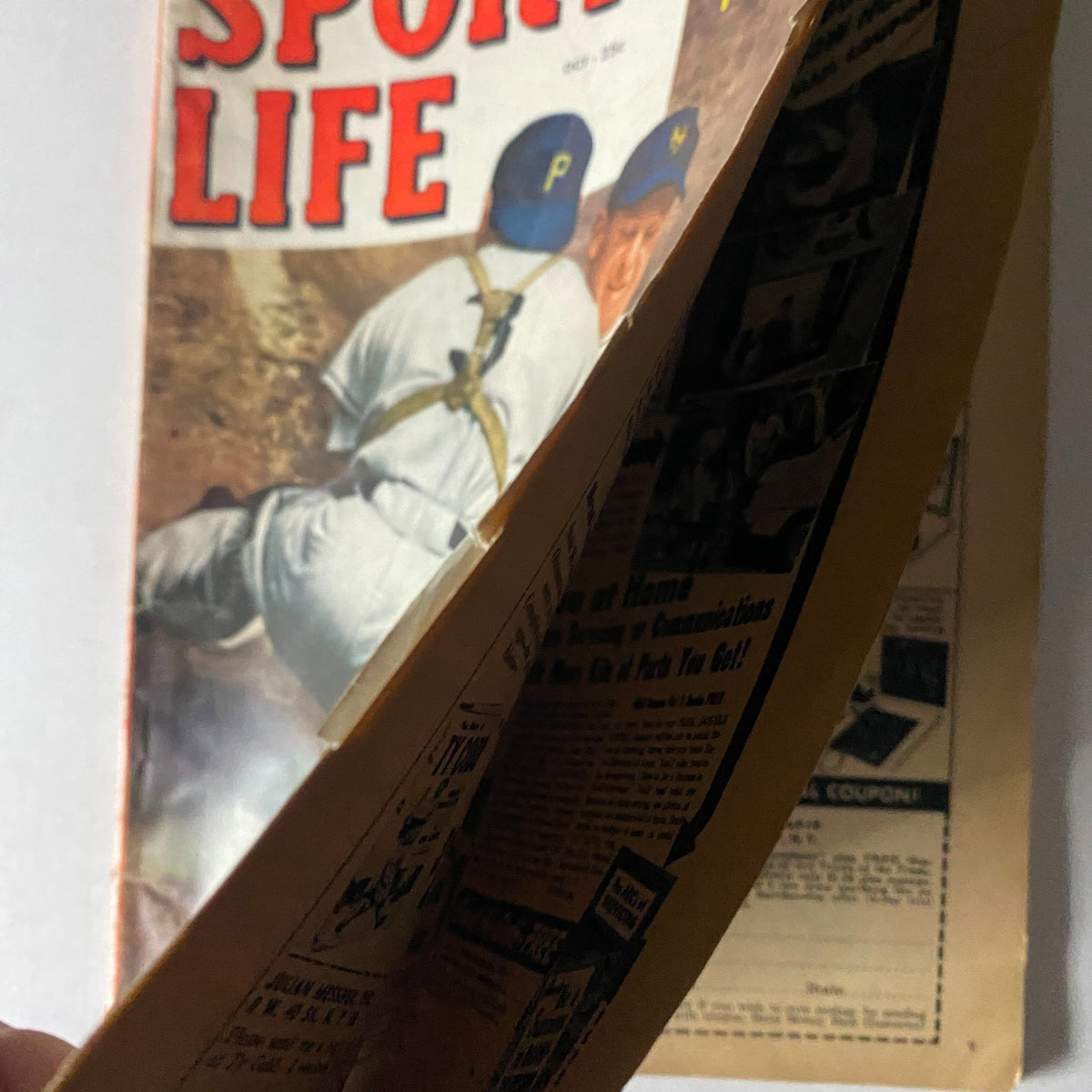 Side view of the October 1952 Sport Life Magazine showing the spine and pages with a baseball action scene on the cover.