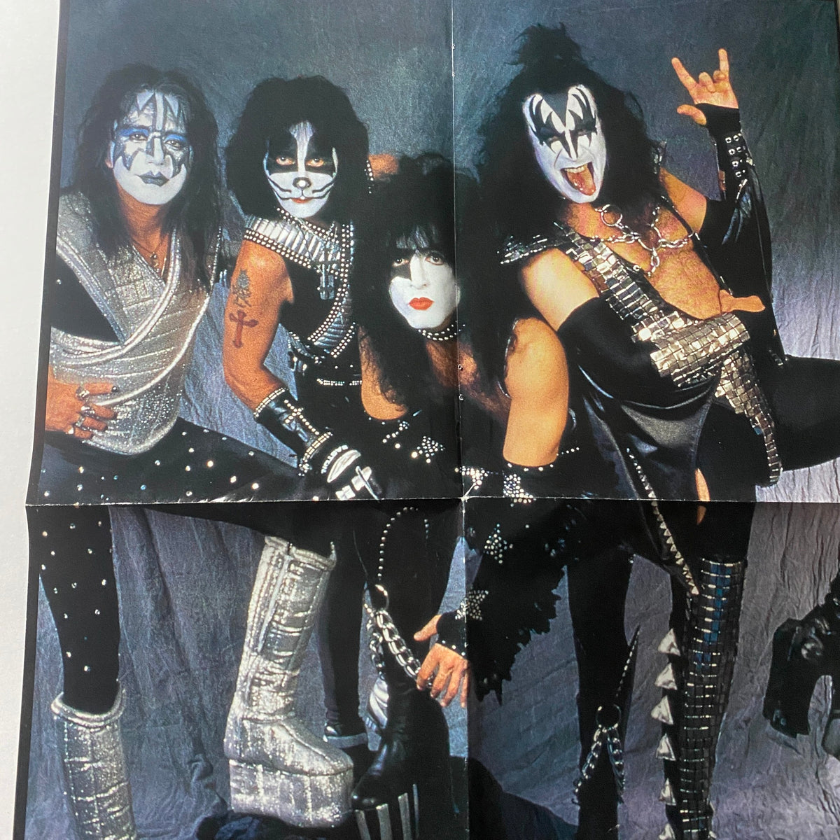 Interior foldout image from '1997 The Kiss Years' by Barry Levine, displaying KISS band members in striking costumes and dramatic poses, celebrating their legendary rock presence.