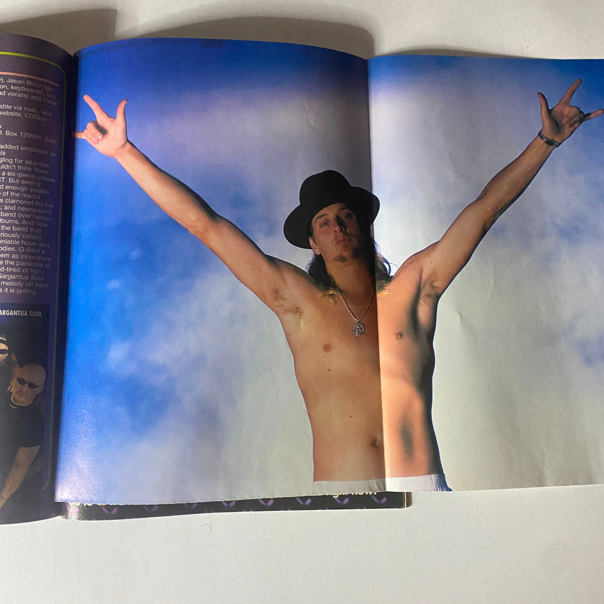 Kid Rock striking a pose with arms raised in Metal Edge Magazine 2000, representing the bold rock and heavy metal culture of that era.