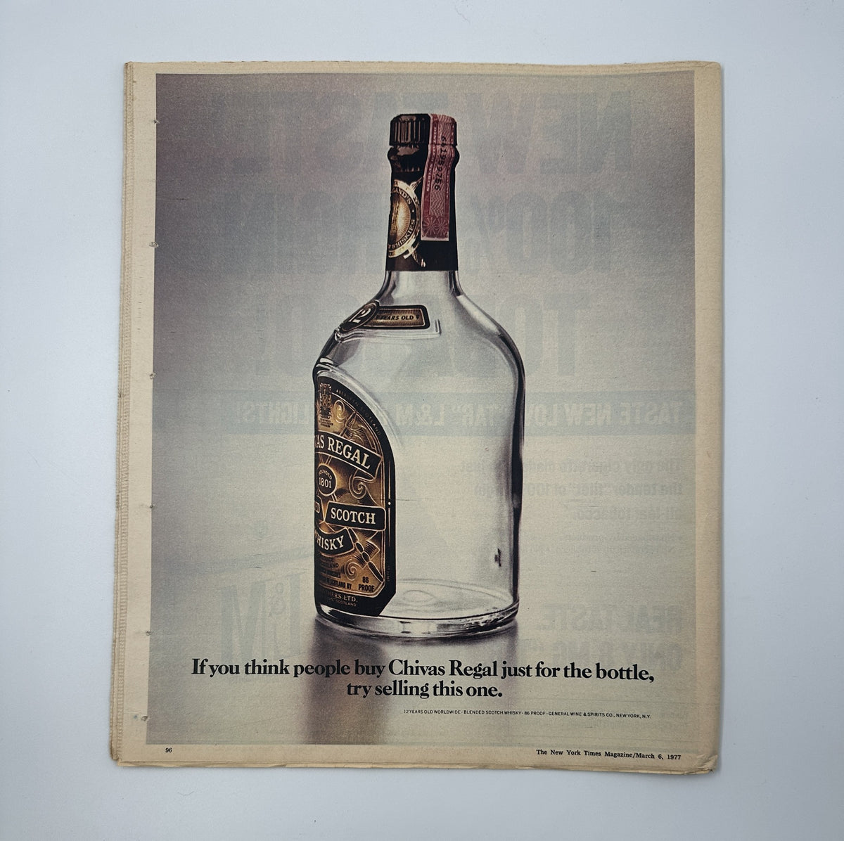 Advertisement page in The New York Times Magazine from March 6, 1977, featuring a Chivas Regal whisky ad with a clear bottle and the text 'If you think people buy Chivas Regal just for the bottle, try selling this one.'