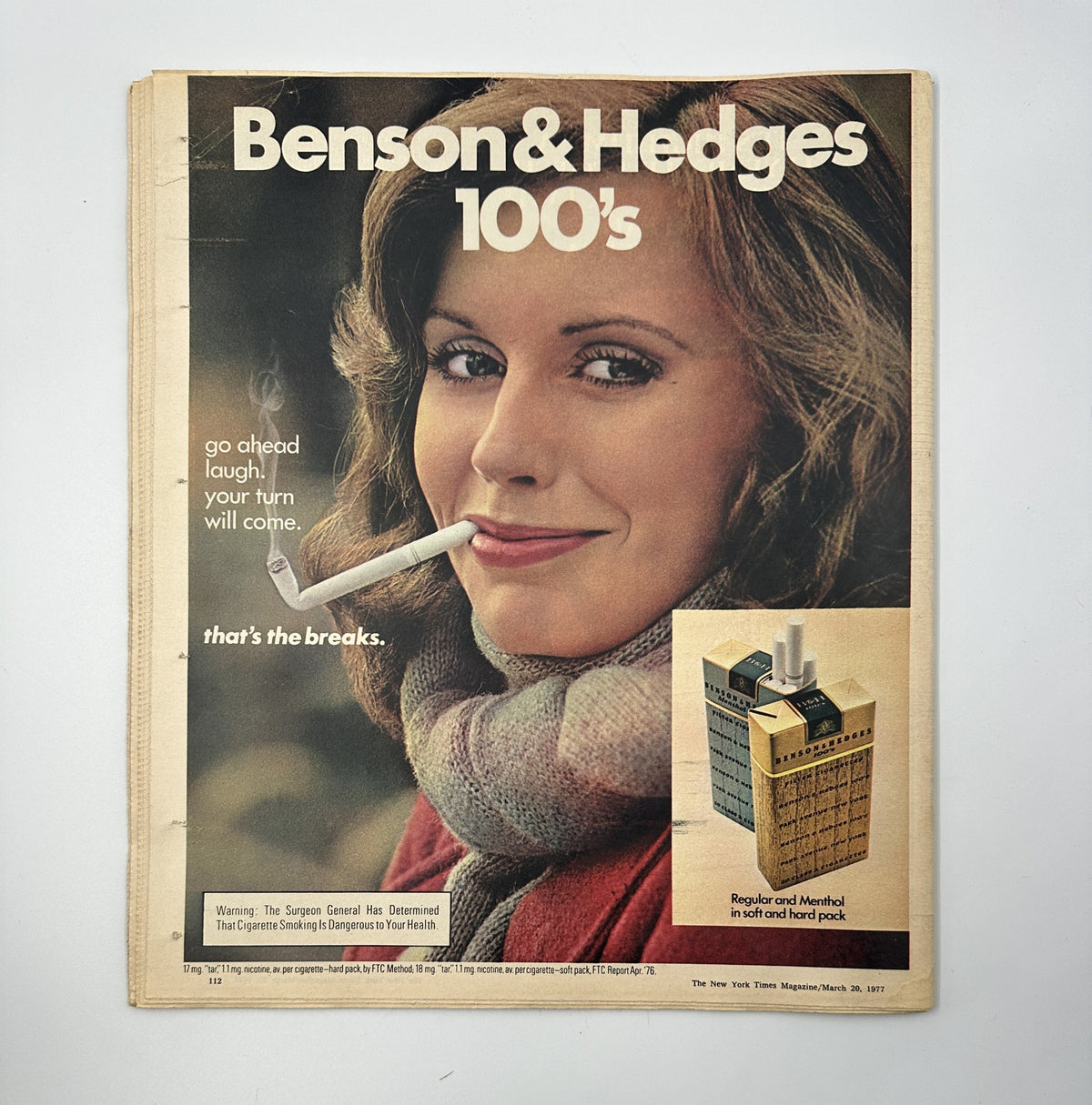 Advertisement from The New York Times Magazine March 20, 1977 for Benson & Hedges cigarettes, featuring a woman smiling with a cigarette, reflecting vintage advertising aesthetics of the era.