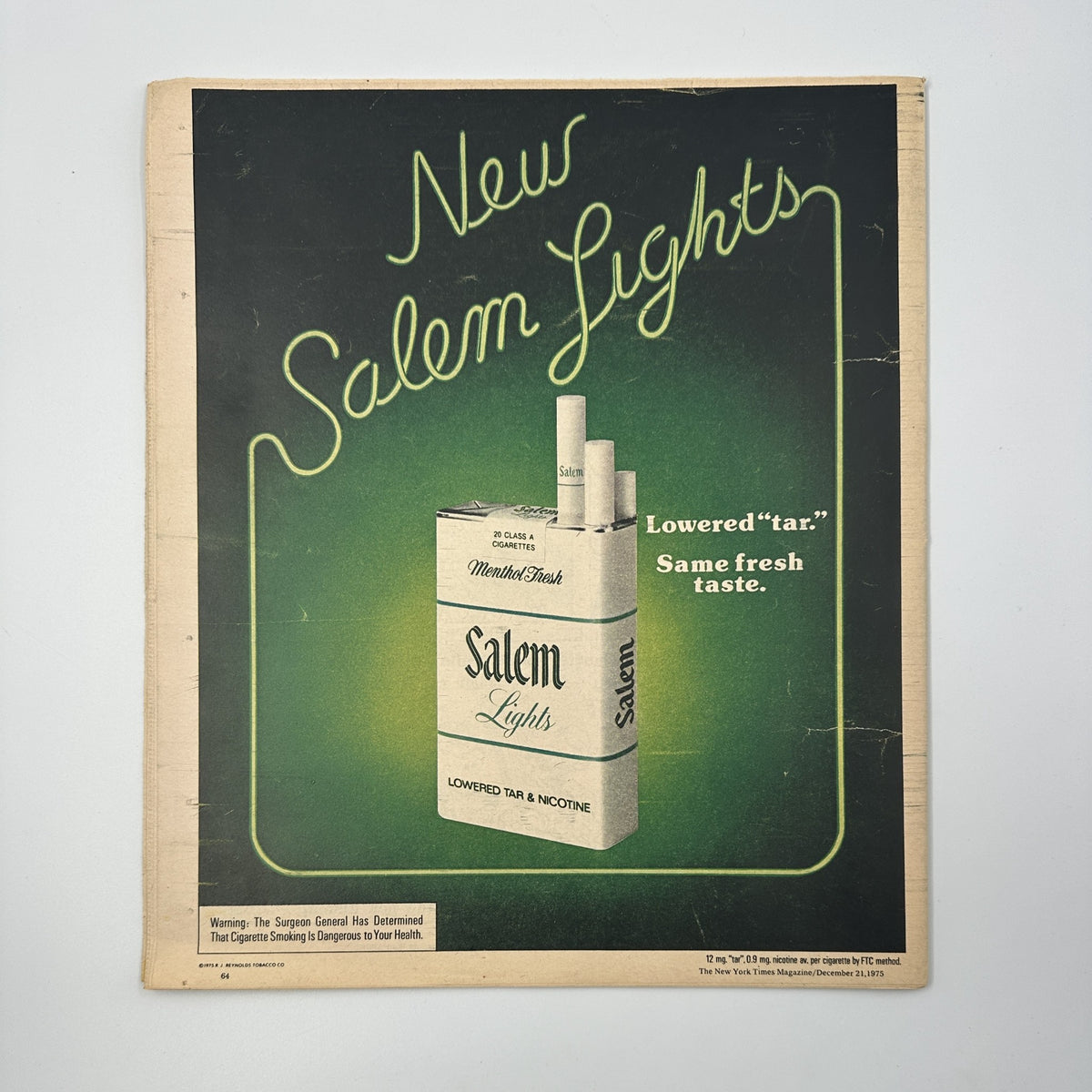 The back cover of The New York Times Magazine December 21, 1975, featuring an advertisement for New Salem Lights cigarettes, emphasizing the slogan 'Lowered tar. Same fresh taste.' This vintage ad reflects the marketing style of the 1970s.