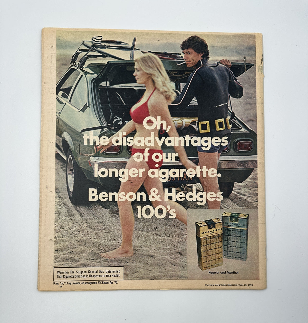 The New York Times Magazine June 22, 1975 back cover advertisement for Benson & Hedges cigarettes, featuring a model on the beach and highlighting the disadvantages of longer cigarettes.