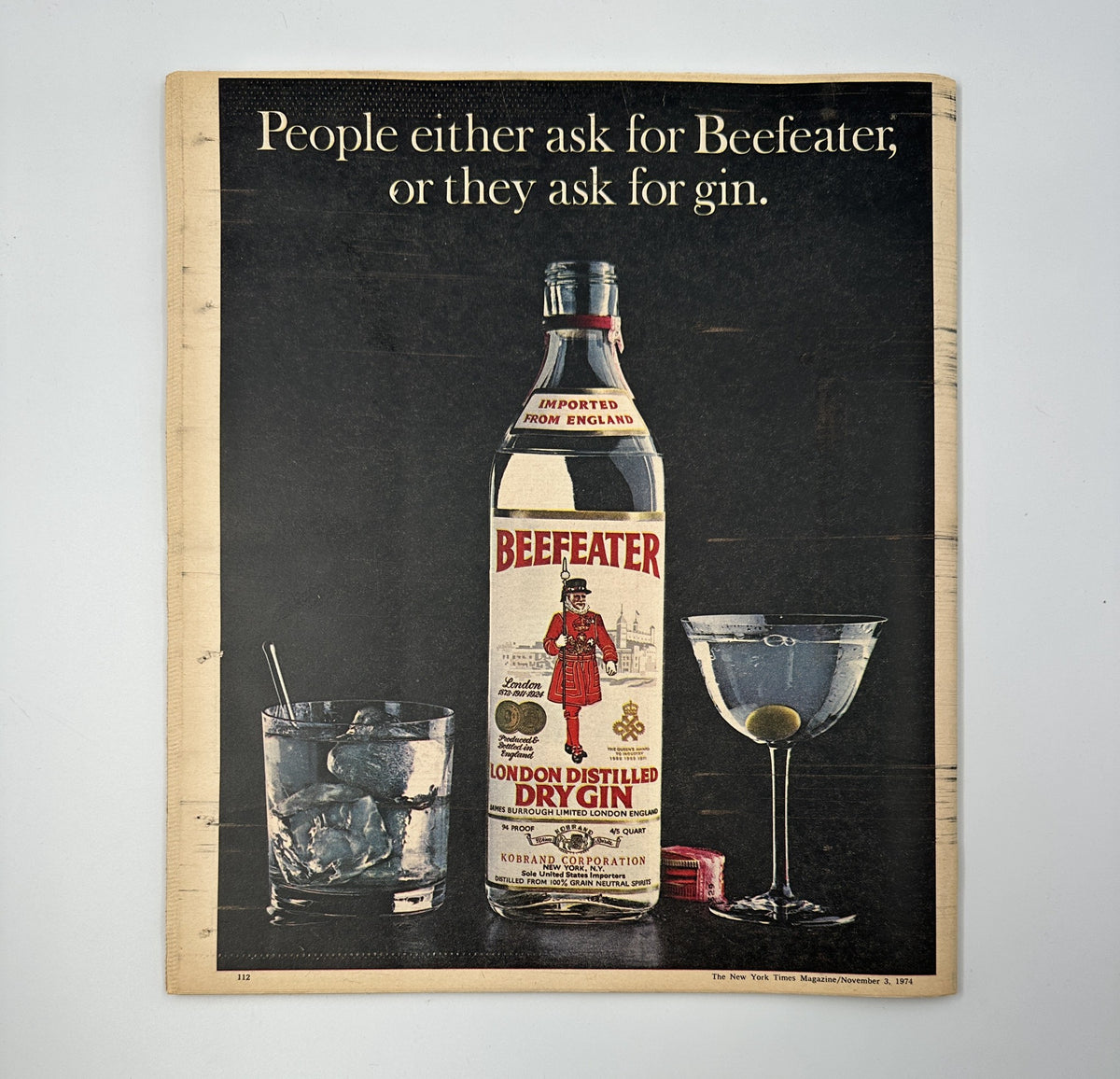 An advertisement from The New York Times Magazine November 3, 1974, featuring Beefeater gin with a bottle and cocktail setup, illustrating classic drink culture in an elegant presentation.