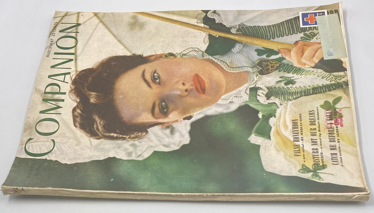 Alternate view of the Woman’s Home Companion Magazine March 1947 cover, showcasing the model in a vintage outfit with an umbrella, advertising content like 'False Honeymoon' and 'Catch Me Before I Kill!'
