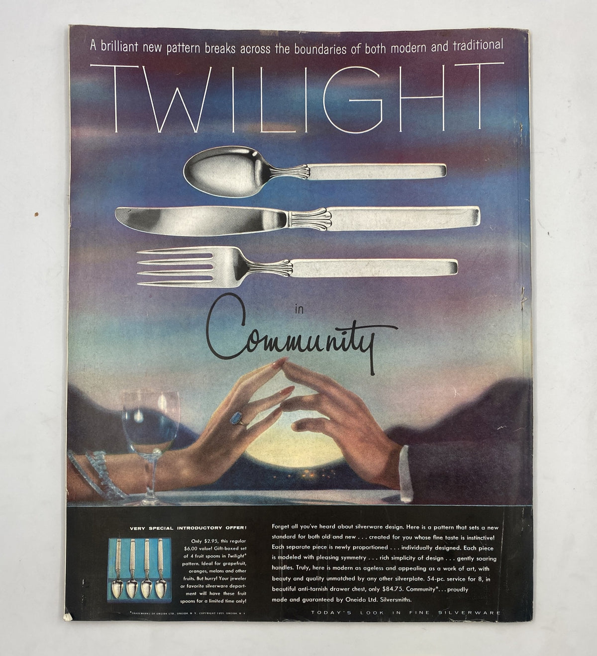 Back cover of Woman’s Home Companion Magazine October 1955, displaying an advertisement for Twilight in Community, featuring elegant silverware against a serene backdrop.